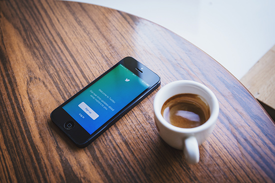 twitter sign upp page on iphone with coffee next to it on a wood table. 3 social media marketing mistakes you should avoid, blog by future access in st catharines